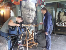 The filming of the final stage of the Bob Mendes portrait painting by Peter Engels