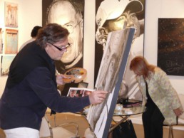 Peter Engels working on the Sean Connery portrait painting on board of the mega yacht Sea Fair during Art Basel Miami