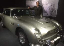Artist Peter Engels studying the details of the actual James Bond Aston Martin DB5